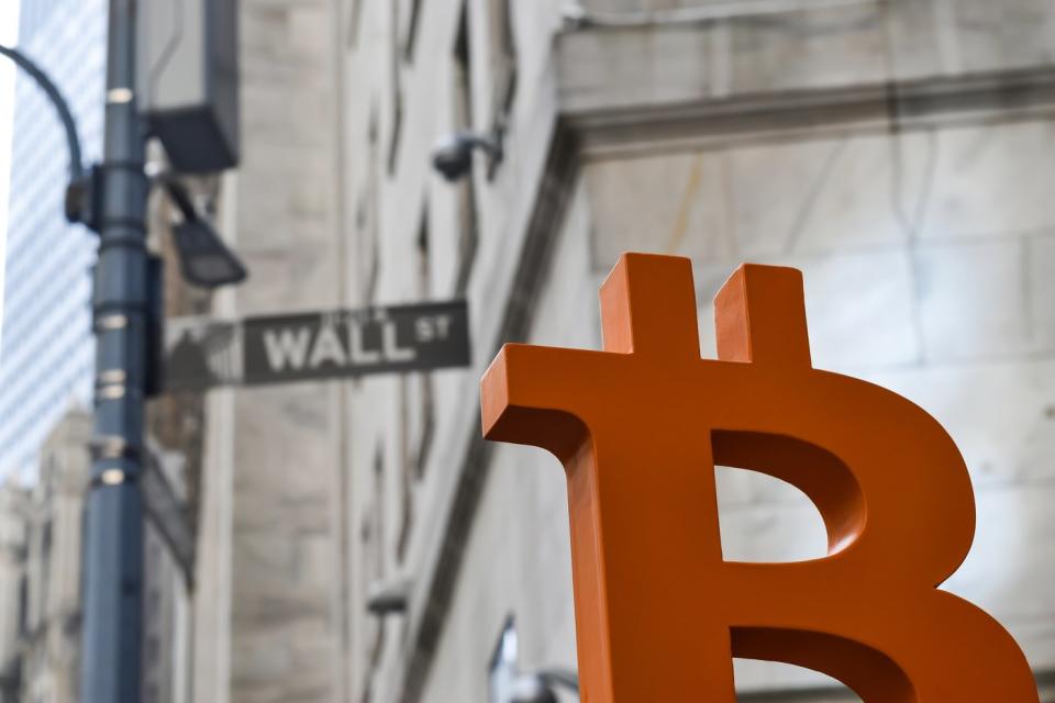 Orange Bitcoin symbol on Wall Street.