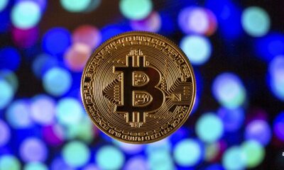 gold bitcoin on colourful background